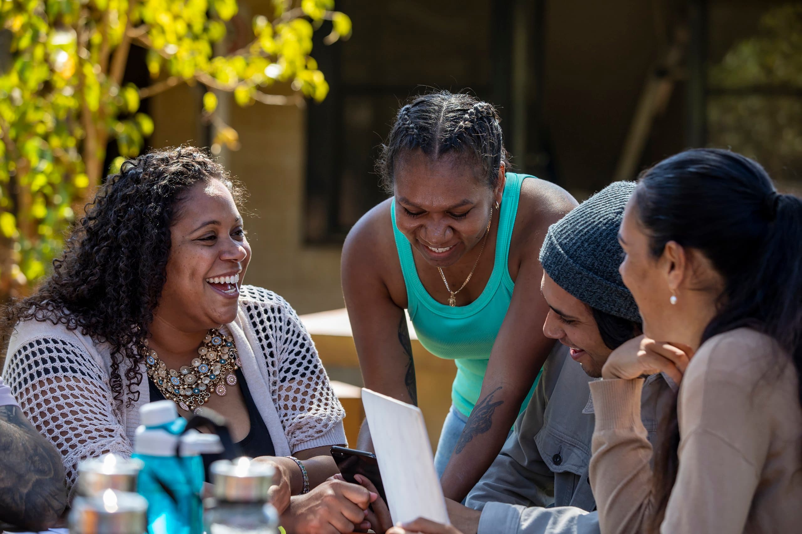 group sits outside an laughs