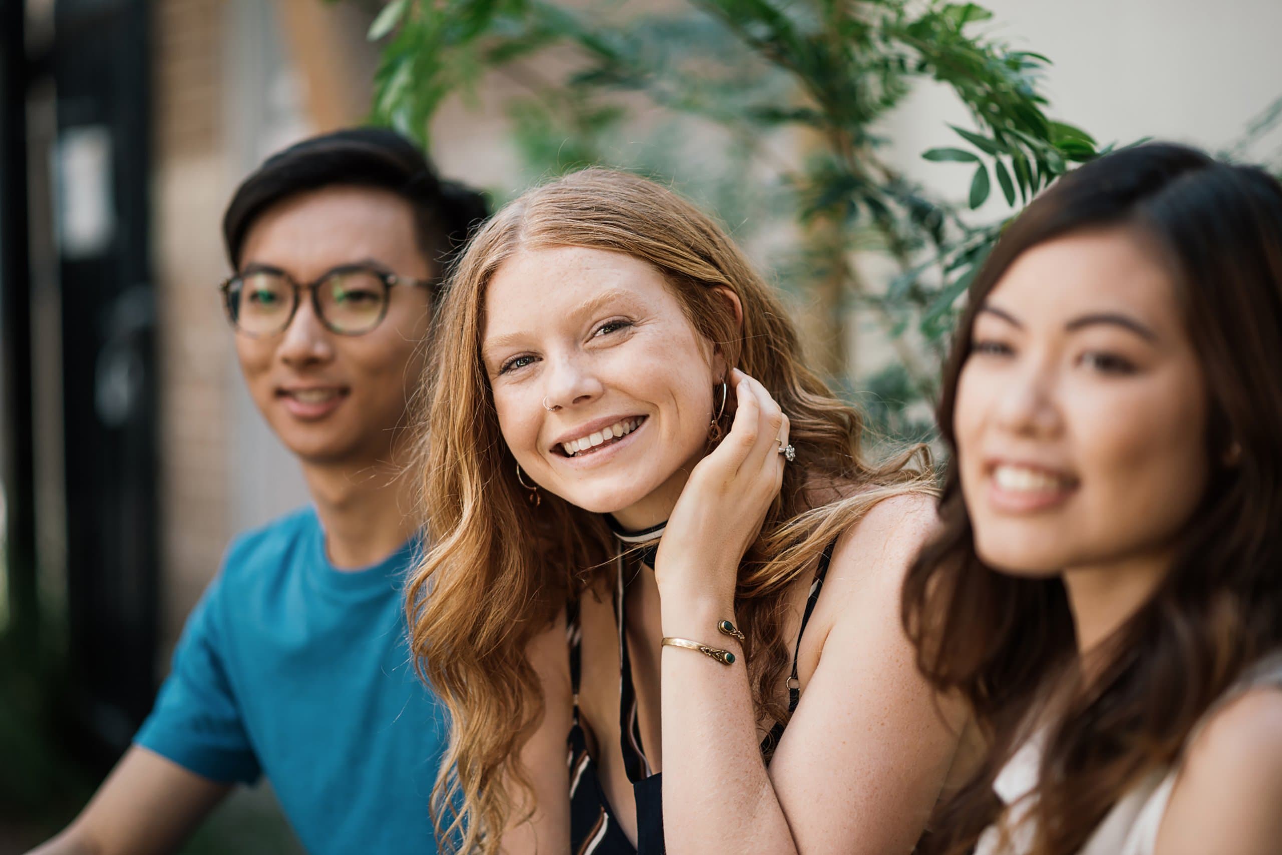 young woman sits with friends