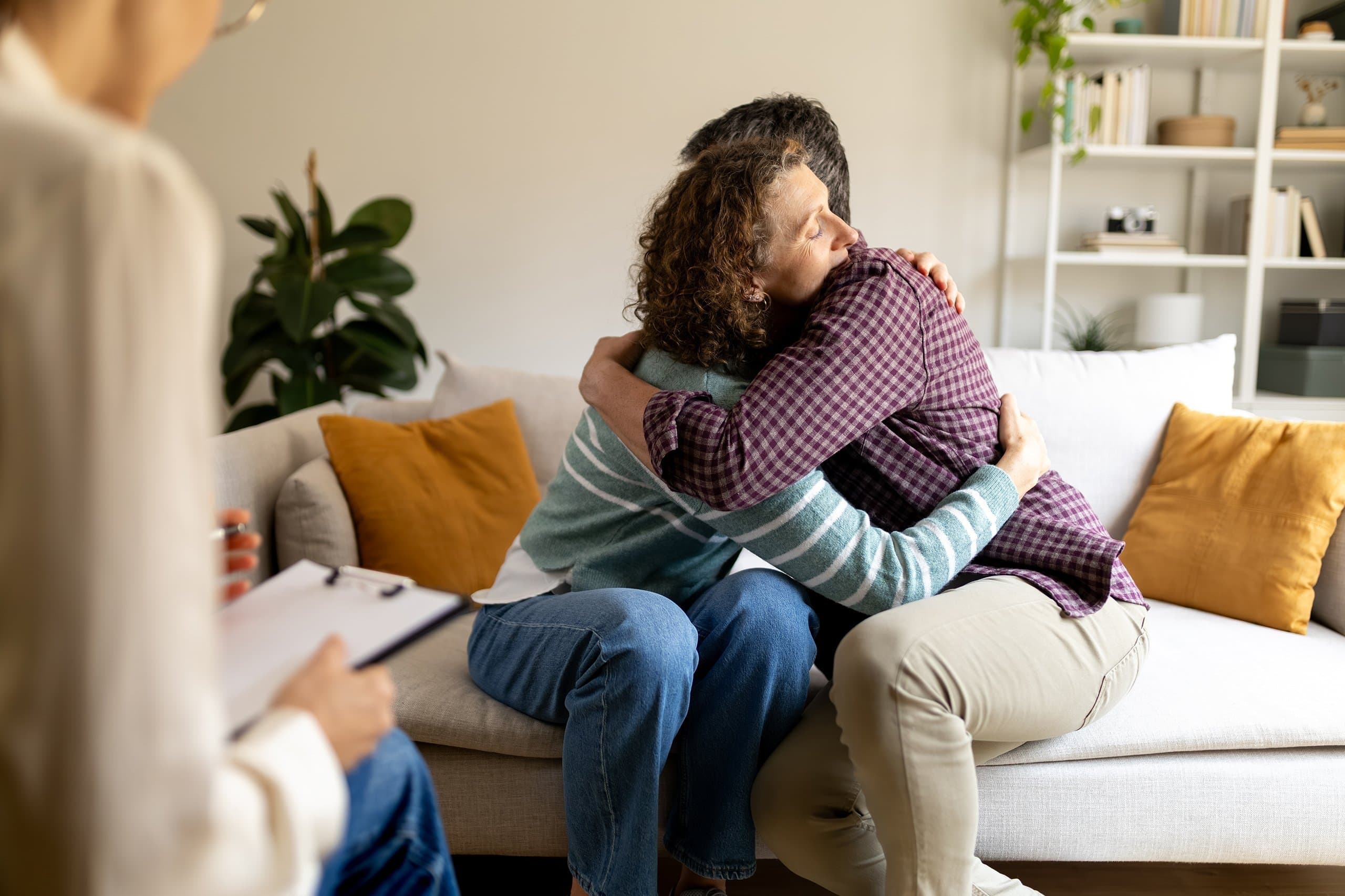 man & woman hugging in counselling session