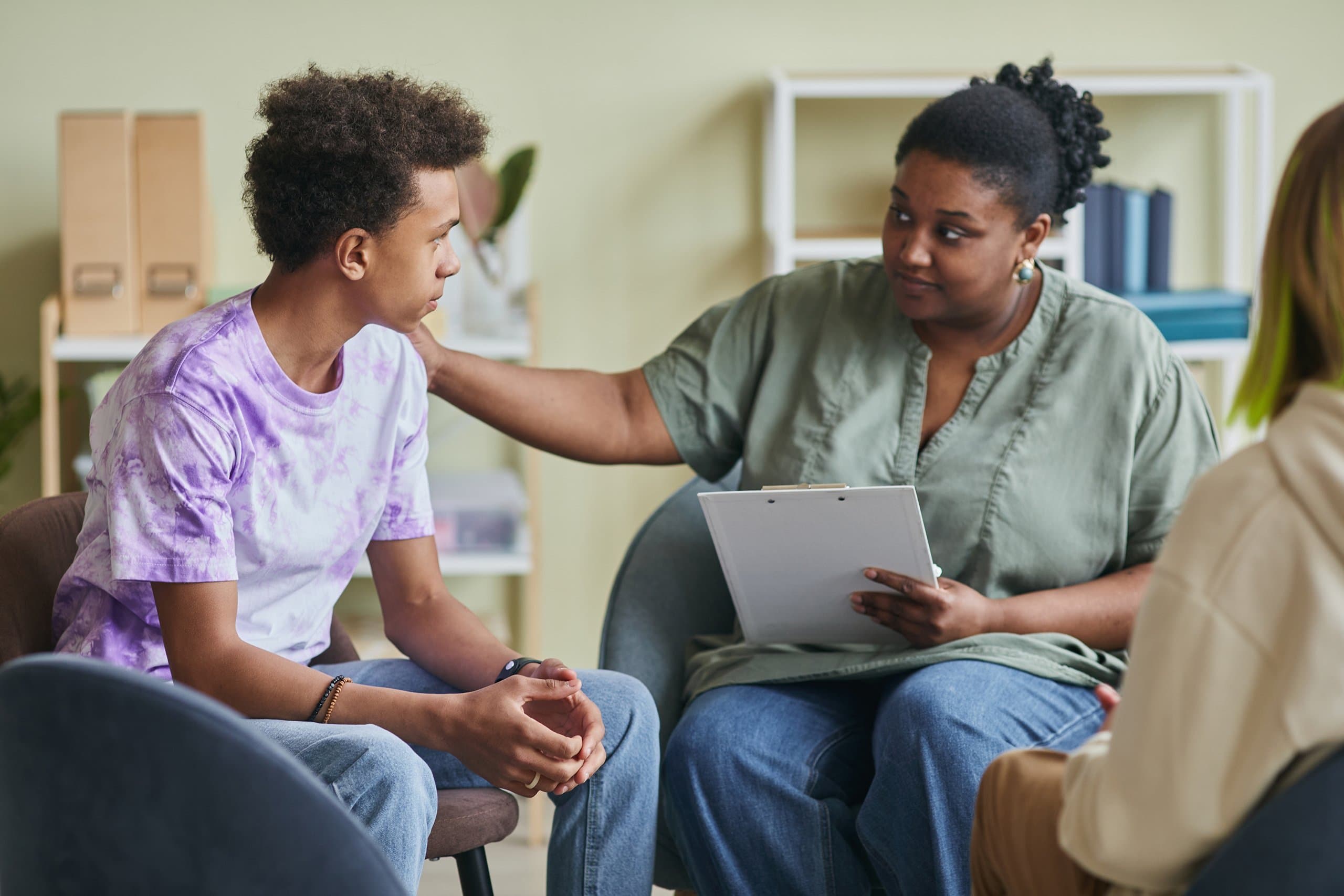counsellor helps young man during session
