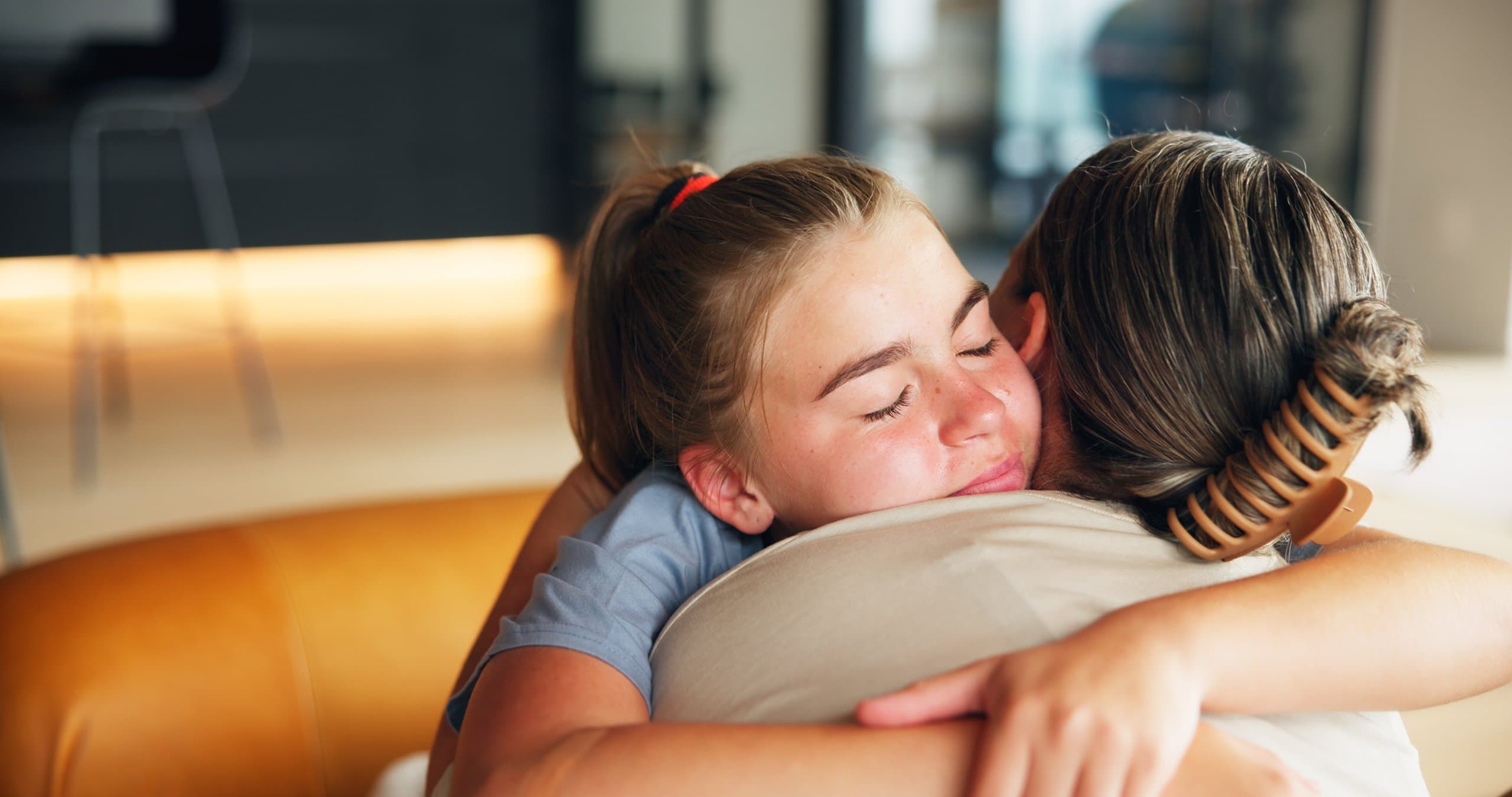 mother & daughter sharing a warm hug