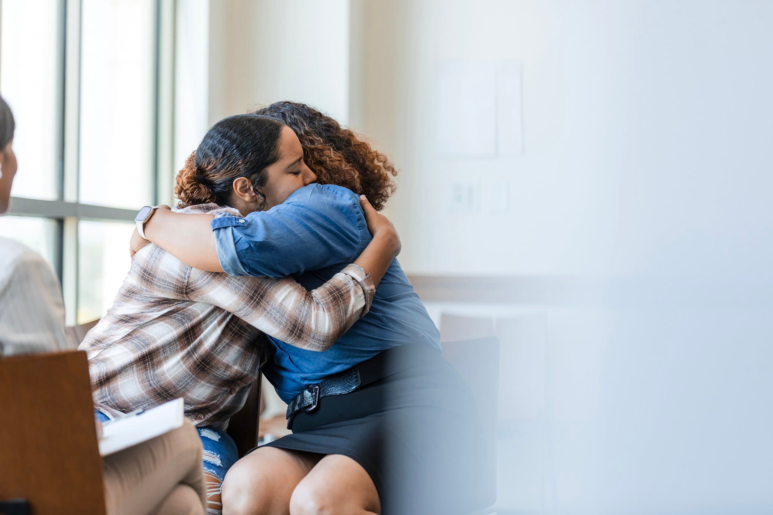 two women hugging during counselling